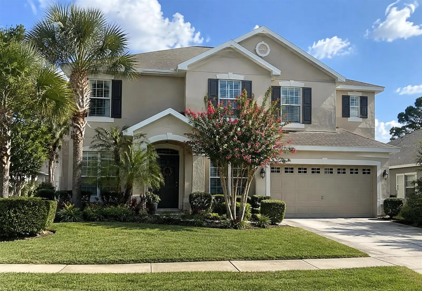 Illustrative image of a two-story stucco home in an Ocala-area neighborhood with white gutters and downspouts